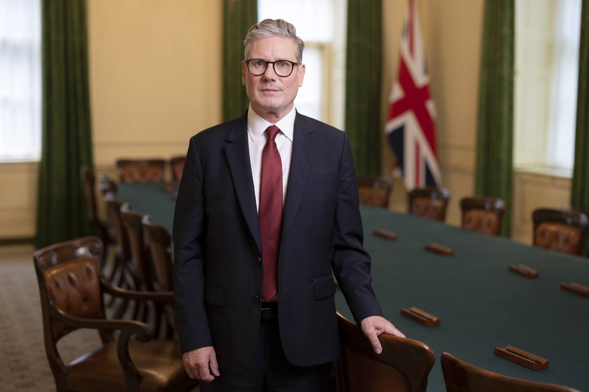 Keir Starmer standing in a government meeting room.